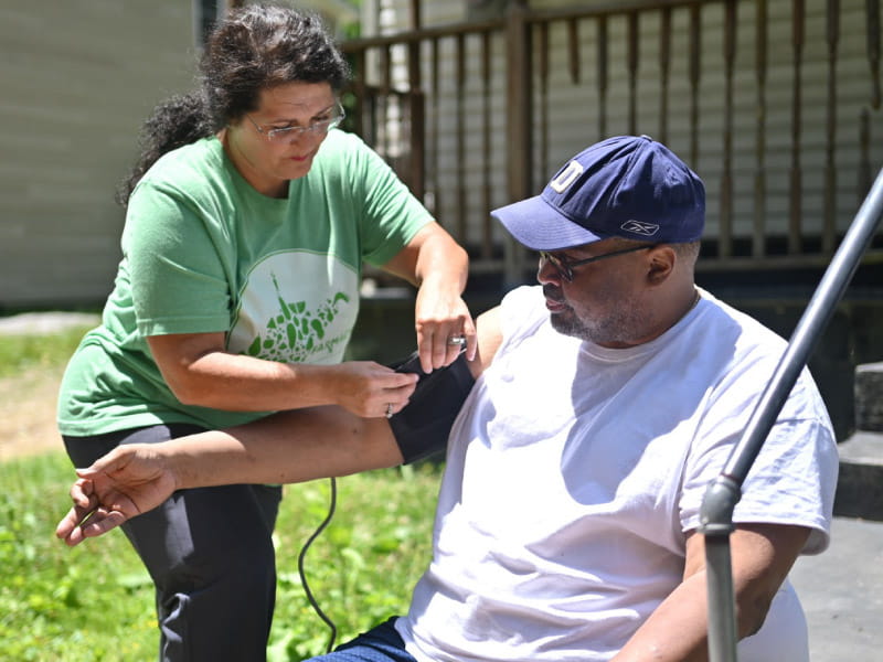 Melissa Justice, a registered nurse and community health worker coordinator at Williamson Health and Wellness Center, helps Craig Warren stay on top of his blood pressure. 