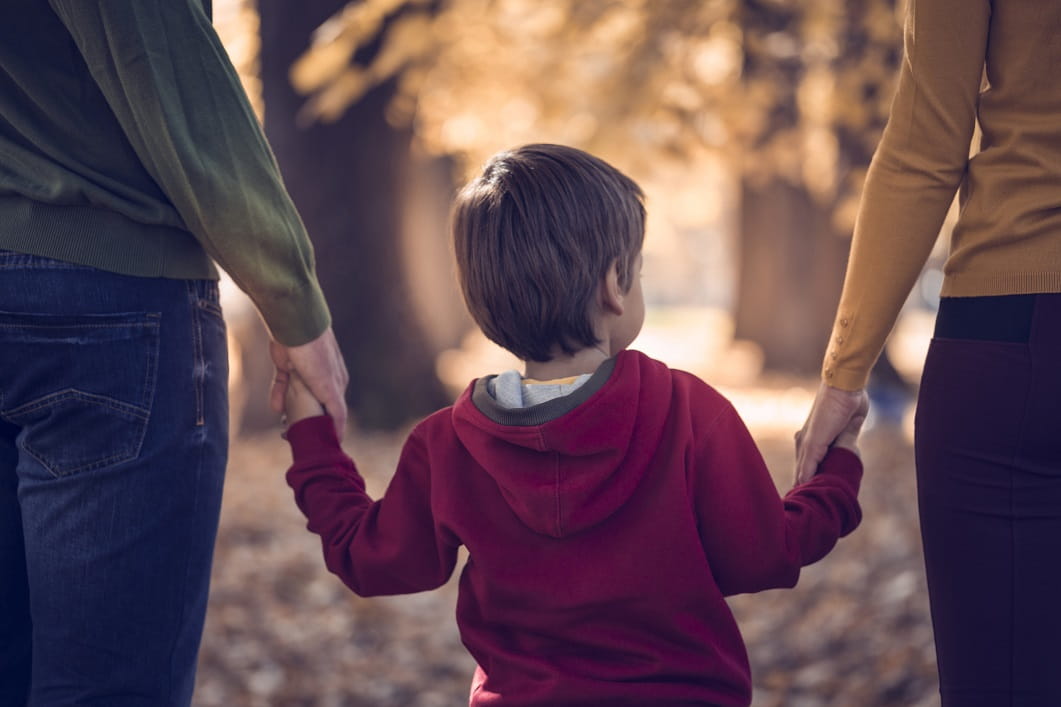 child holding adult's hands