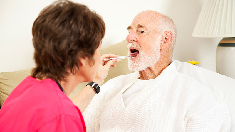 man having temperature checked