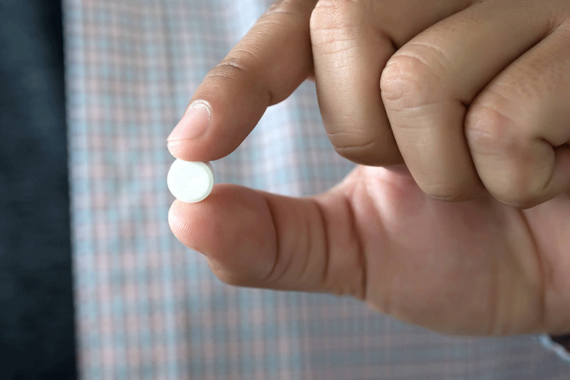 man holding a pill