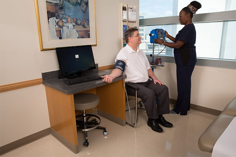 nurse checking a patient's blood pressure