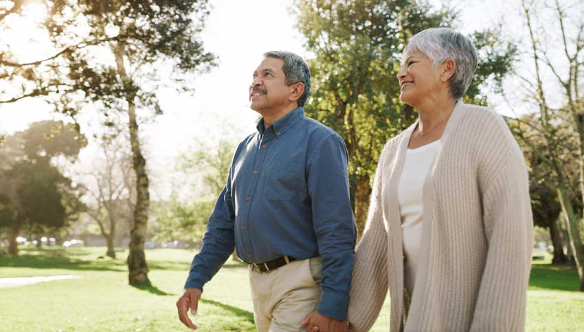 Couple holding hands walking outside