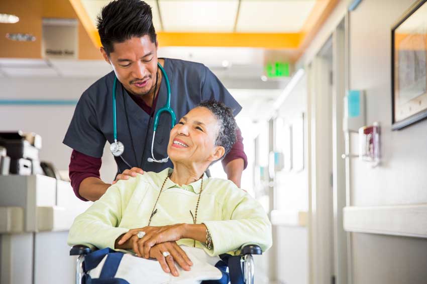 Woman in wheelchair with nurse