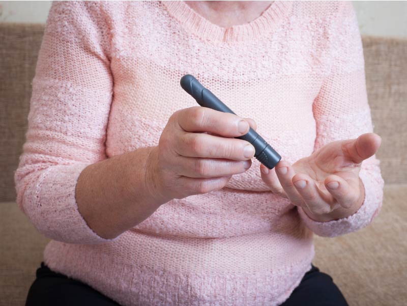 Diabetic woman testing blood sugar.