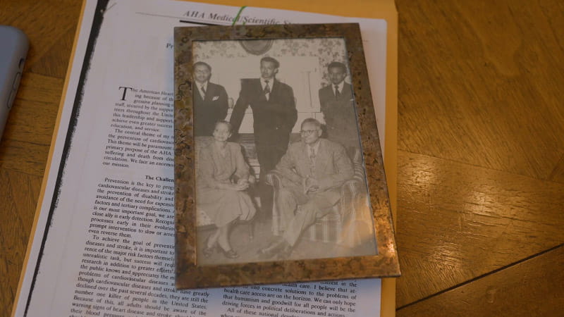 A photo of Dr. Edward Cooper (top right) with his family sits atop a copy of the address he gave in 1992 at Scientific Sessions as president of the American Heart Association. (Courtesy of Dr. Edward Cooper via Mirar Media Group for the American Heart Association)