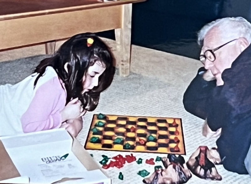 Dr. Eugene Braunwald plays a game of Dino checkers with his granddaughter Rachel in 2003. (Photo courtesy of the Braunwald family)