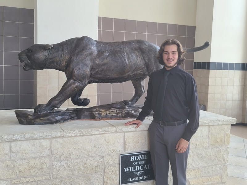 Dylan Dorrell in front of his school mascot dressed up for his senior yearbook pictures. The photographs arrived in the mail the day he passed away. (Photo courtesy of the Dorrell family)