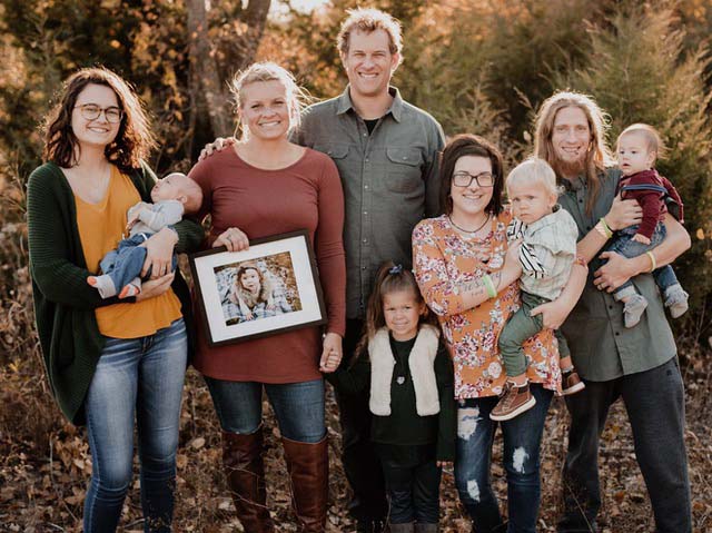 Abel's family and his heart donor family. From left: Kaya Koraleski, holding Deacon Protiva; Wendy Wees, holding photo of heart donor Pressley Bartonek;, Jason Protiva; Kambriah Bartonek; Rheannon Bartonek, holding Abel Protiva; Shaun Bartonek, holding Phoenix Bartonek. (Photo by Wyn Wiley)