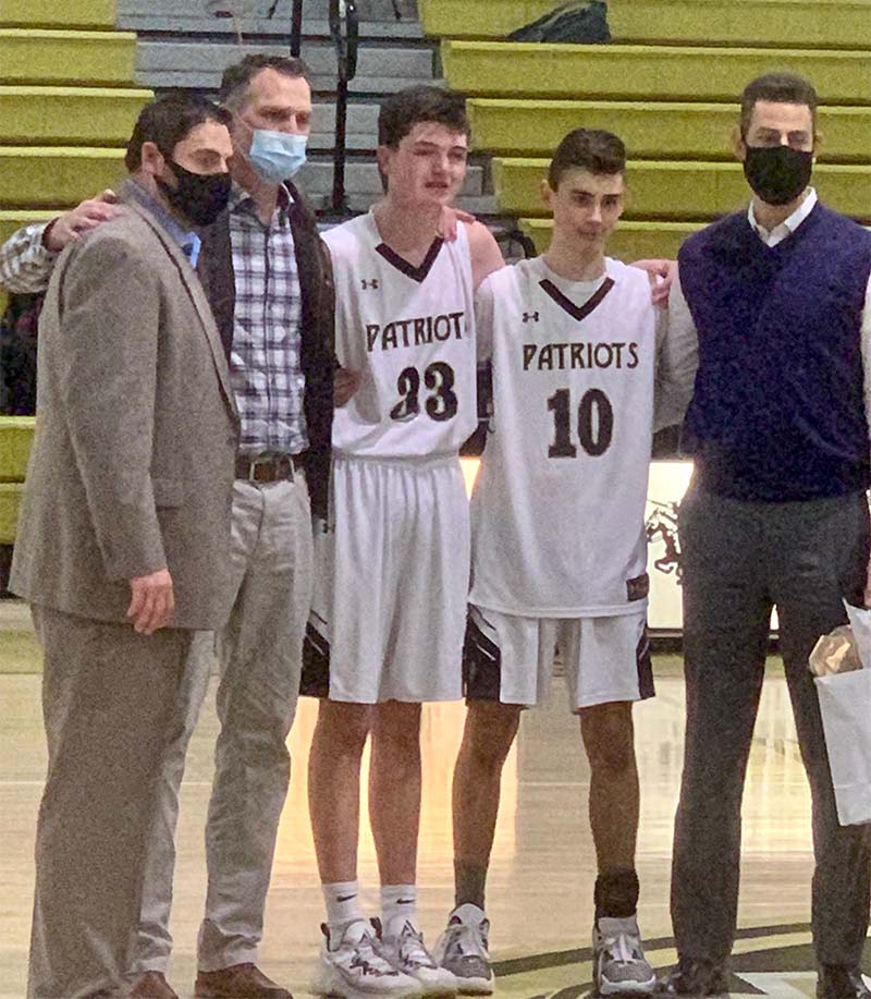 Joe Greco was recognized at a ceremony for saving John Holschuh's life. From left: High school basketball coach Seth Goldberg, John Holschuh, Alexander Holschuh, Joey Greco and Joe Greco. (Photo courtesy of John Holschuh)