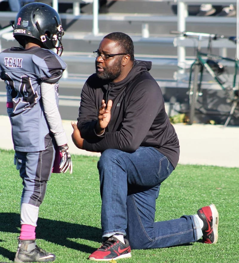 Brian coaching Jahari. (Photo courtesy of LaKeisha Barron-Brown)