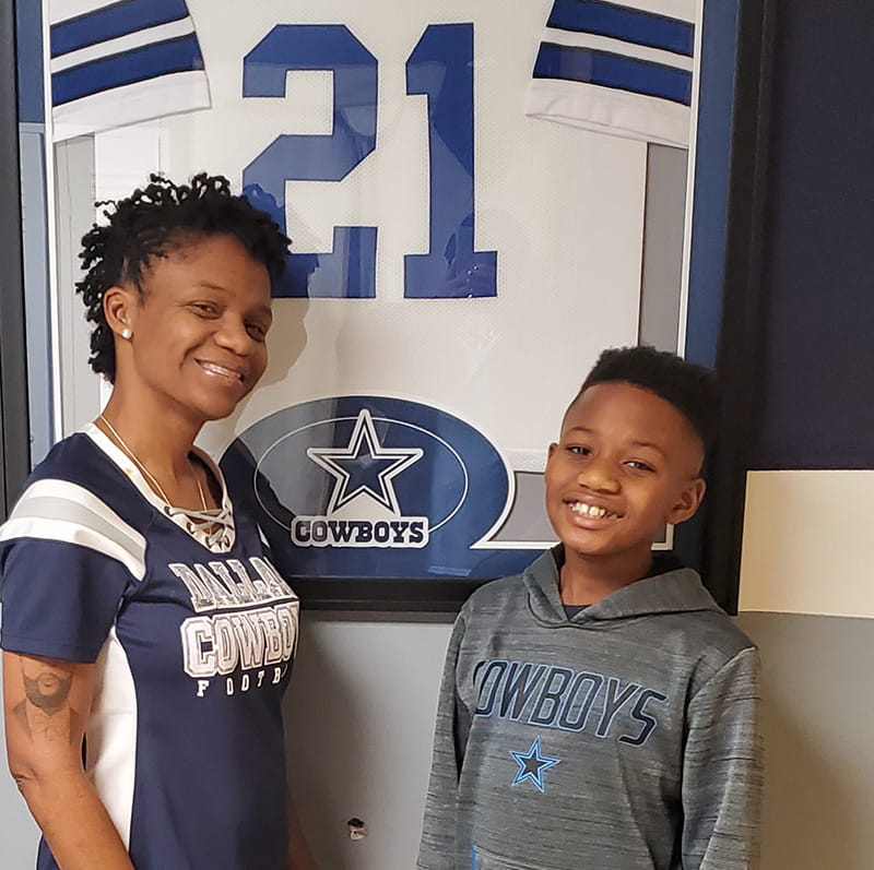 LaKeisha and Jahari in their Dallas Cowboys-themed basement. (Photo courtesy of LaKeisha Barron-Brown)