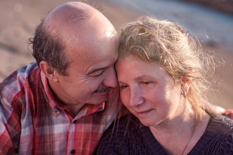 man and woman sitting on the ground