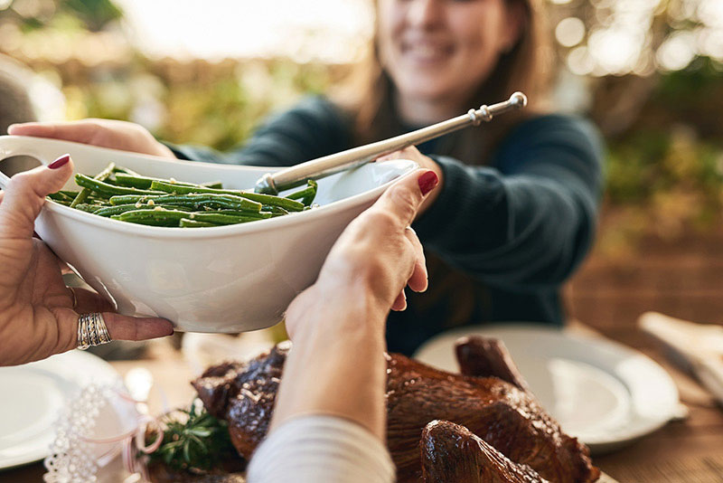 Women at table sharing vegetables