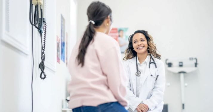 stock photo of female patient speaking with young female doctor