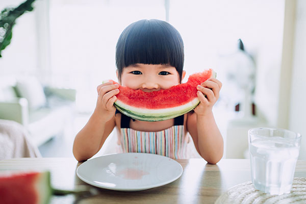 Asian toddler eating watermelon Asian toddler eating watermelon