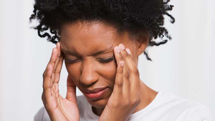 Young woman stressed rubbing temples