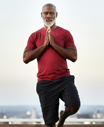 balancing man does yoga