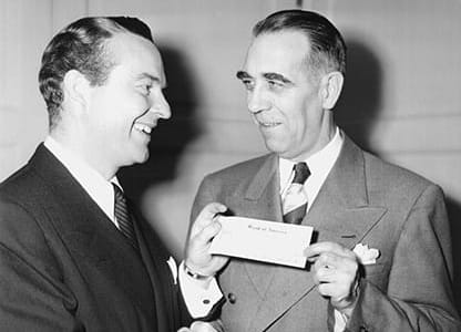 Ralph Edwards (left), host of the radio show "Truth or Consequences," presents the check from The Walking Man contest to American Heart Association President Dr. Arlie R. Barnes in 1948. (American Heart Association archives) Ralph Edwards (left), host of the radio show "Truth or Consequences," presents the check from The Walking Man contest to American Heart Association President Dr. Arlie R. Barnes in 1948. (American Heart Association archives)