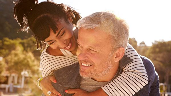 couples piggybacking at beach couples piggybacking at beach