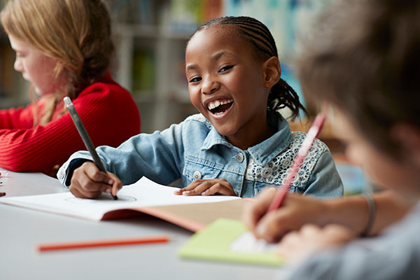 Student smiling at desk  Student smiling at desk