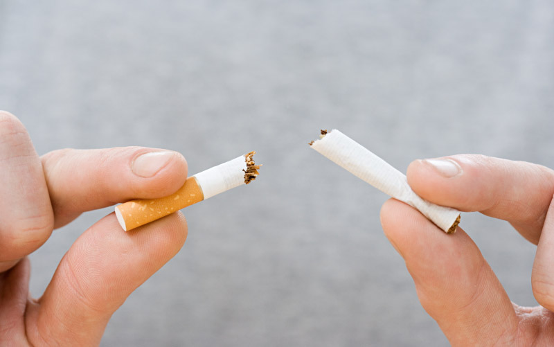 Hands breaking apart cigarette. (Image Source)