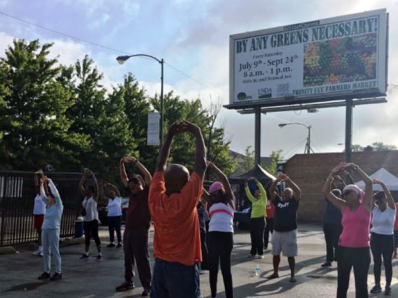 Yoga Ministry at the Trinity Community Farmers Market, where people have access to fruits and vegetables. (Photo courtesy of The Endeleo Institute)