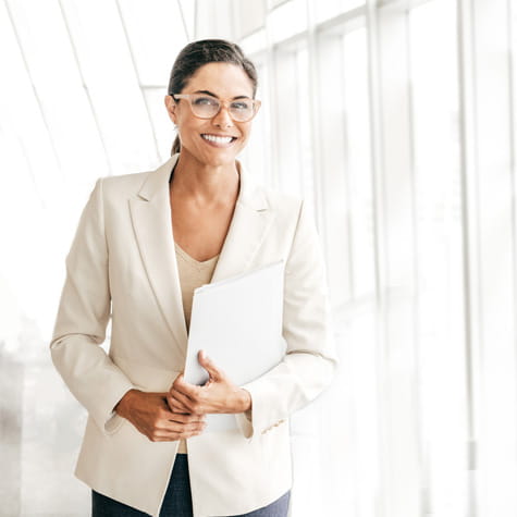 White professional woman holding file folder.