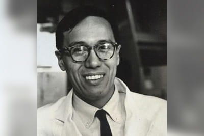 A black-and-white headshot of Richard Kekuni Akana Blaisdell in a labcoat and tie.
