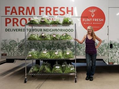 Woman standing with fresh vegetables 